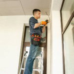 electrician installing exterior camera
